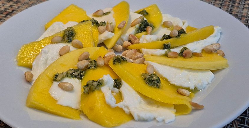 Caprese van mango, pesto en mozzarella.